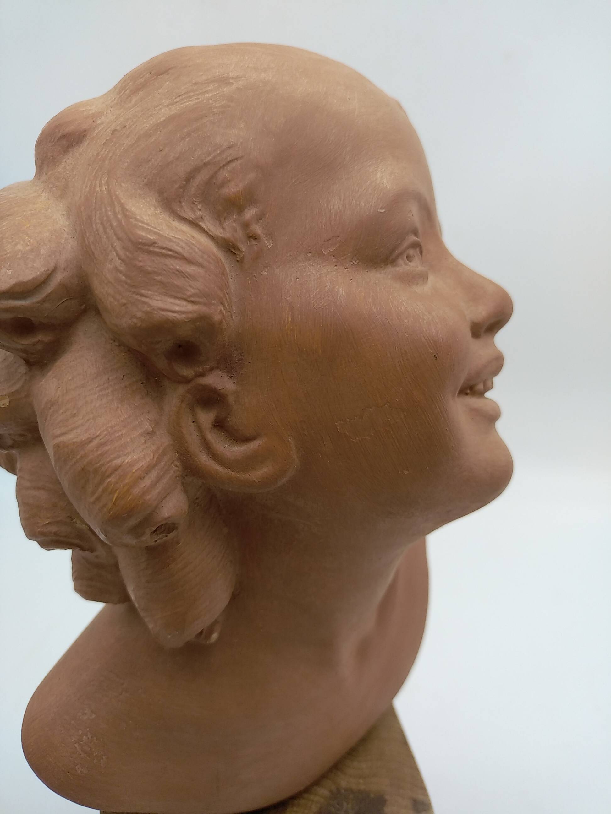Bust young smiling girl. Circa 1900. Art Deco. Signed.
