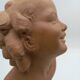 Bust young smiling girl. Circa 1900. Art Deco. Signed.
