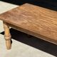 Brown Indonesian teak coffee table, with a border and cylindrical legs H40 L103.