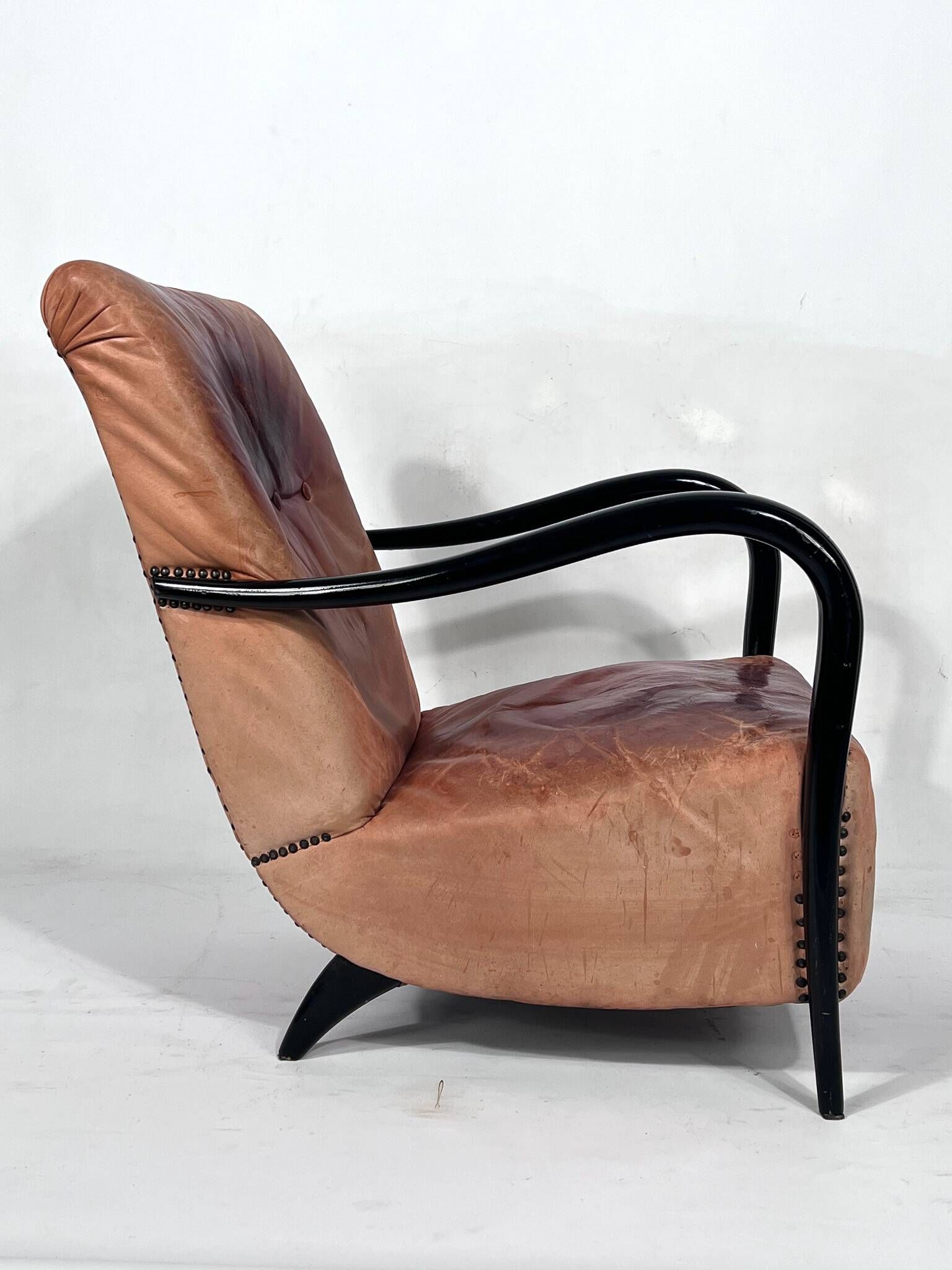 Sculptural Italian Mid-century leather and curved wood armchair from 50s