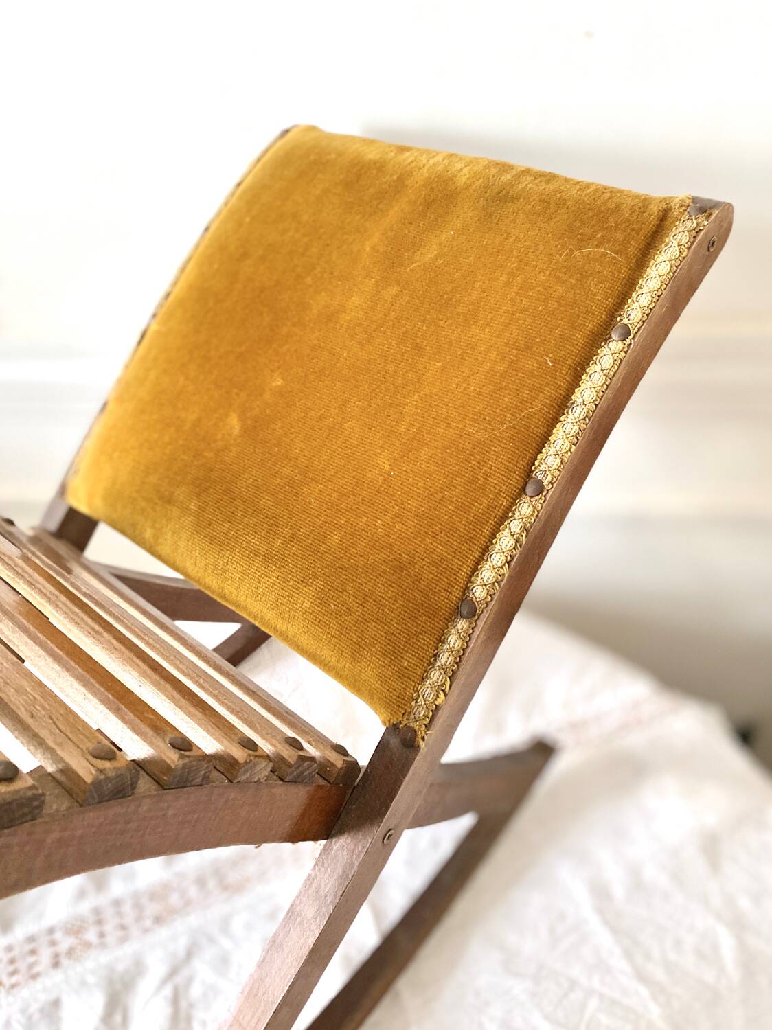 Old wooden rocking footrest with velvet fabric