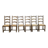 6 dark solid wood dining chairs with rush seats from the 1970s.
