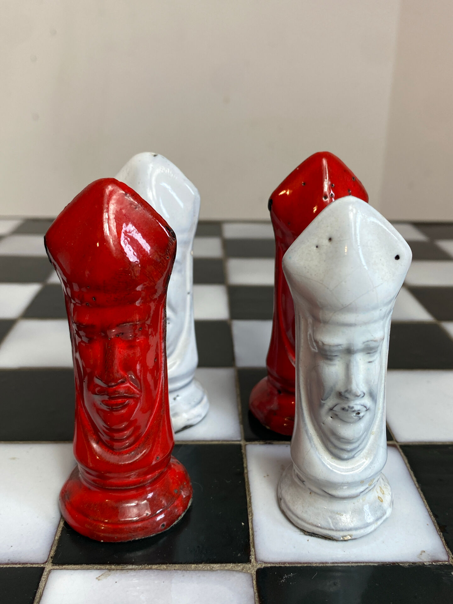 Chess set with ceramic board and pieces.
