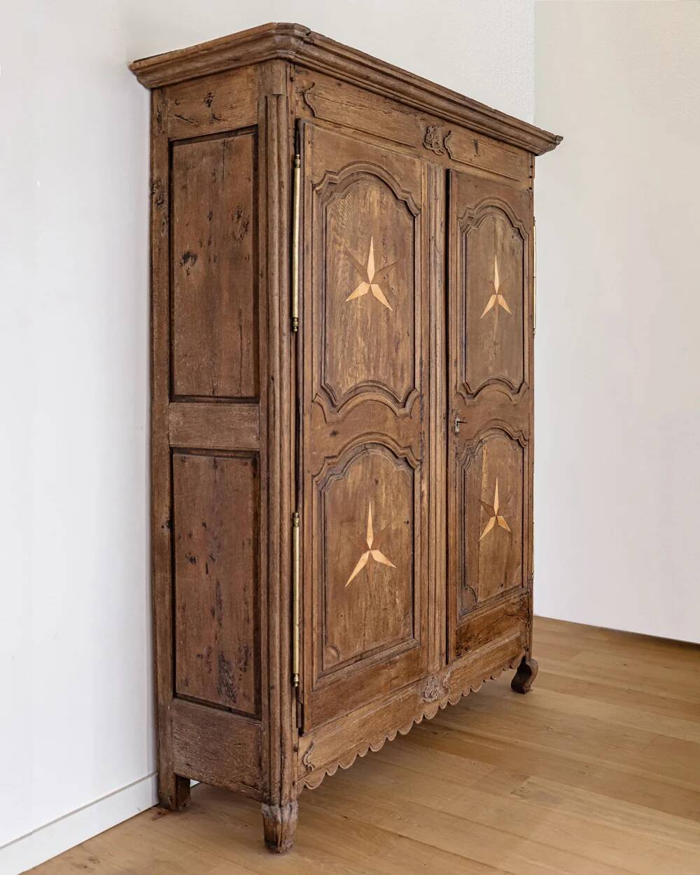 Antique French rustic wardrobe with star inlays.