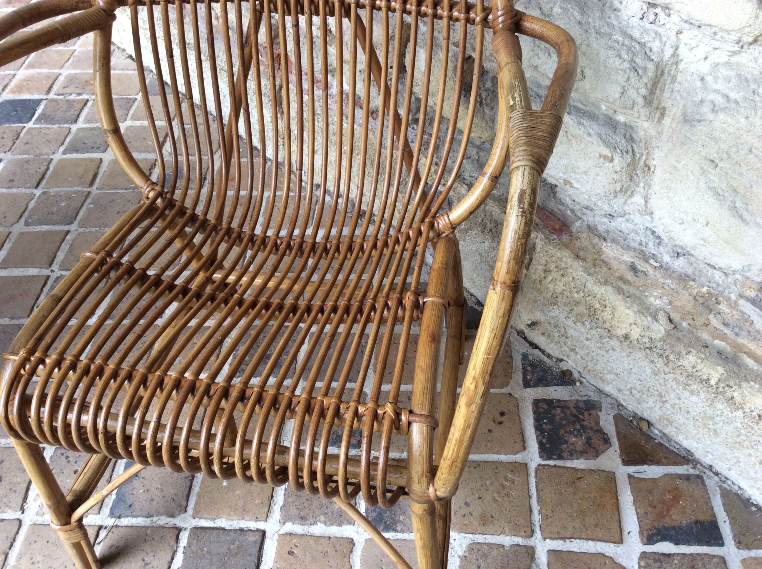 Rattan armchair and his feet rest