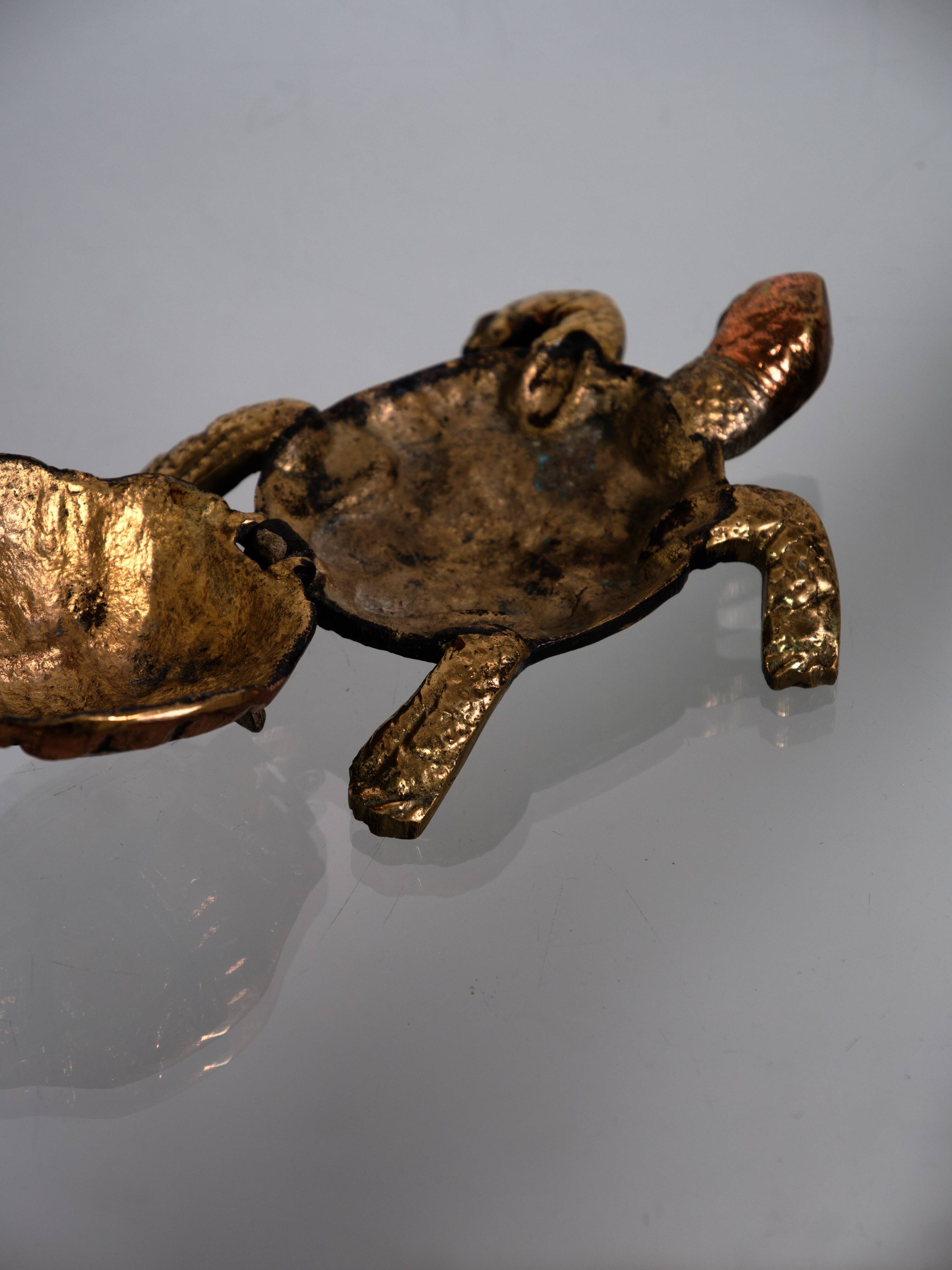 Golden brass turtle in decorative ashtray