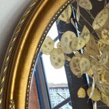 Oval-shaped gilded wooden mirror
