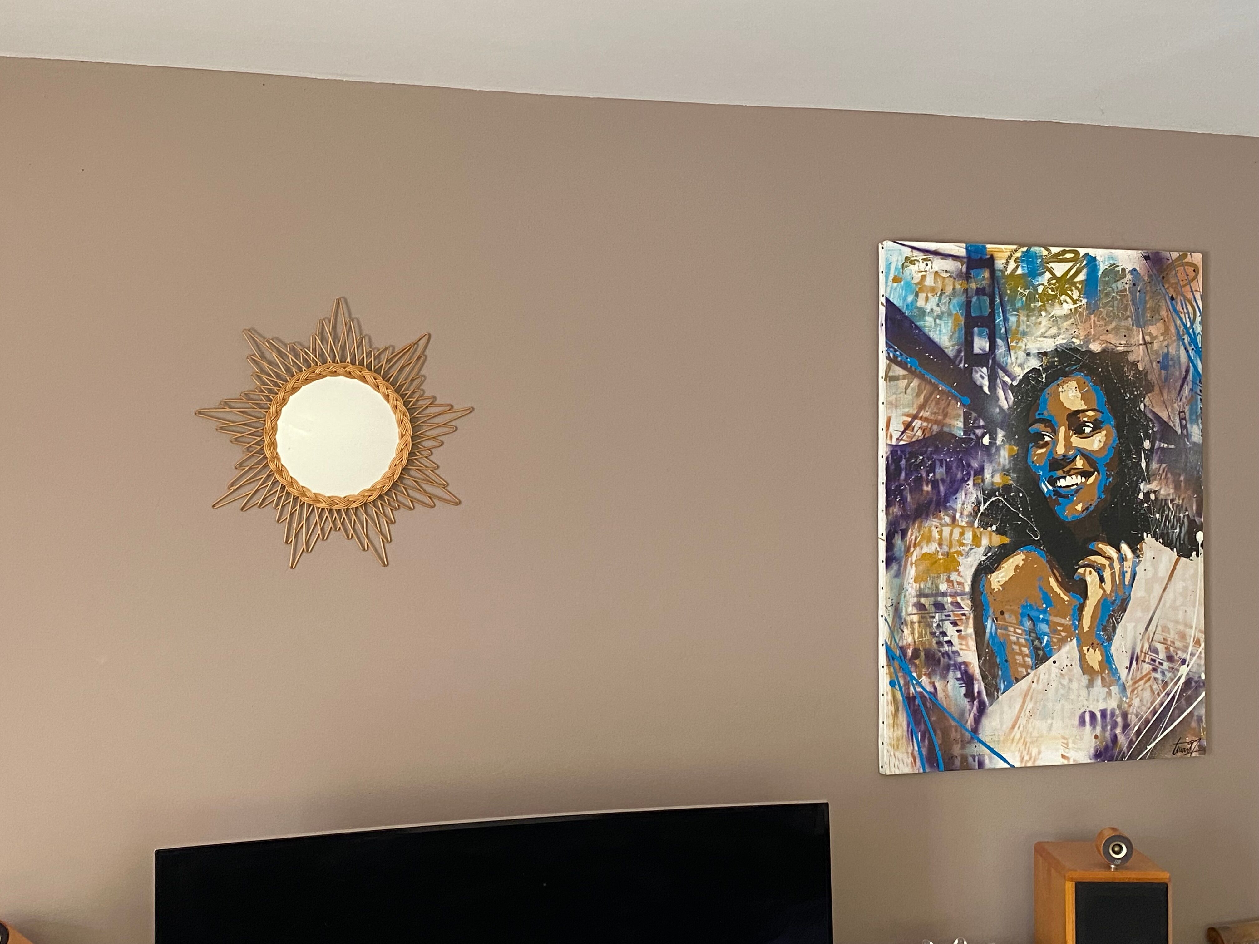 Mirror sun in braided rattan.