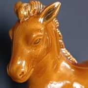 Ceramic horse sculpture with wild glaze and gold, signed Art Deco.