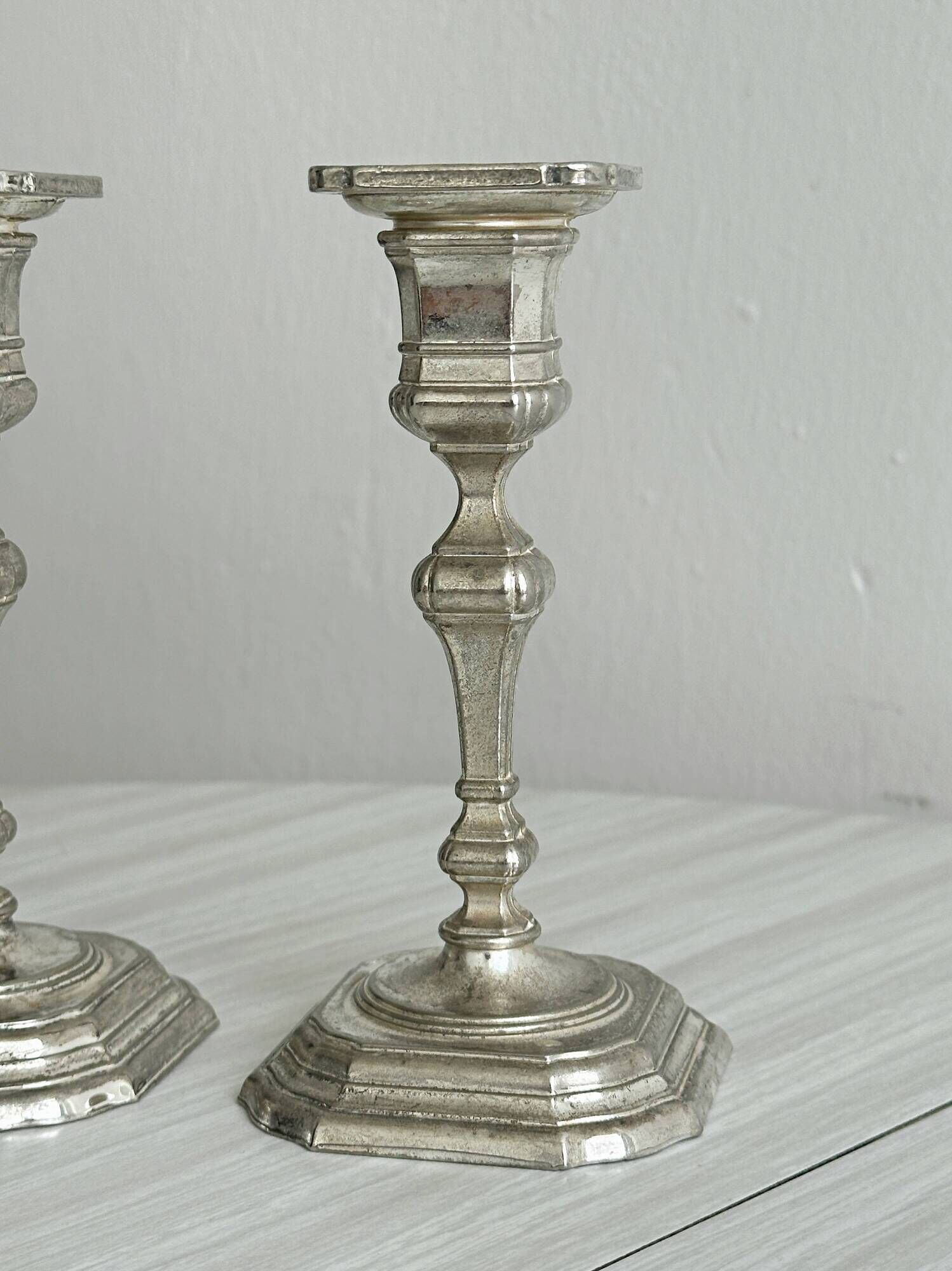 Pair of patinated silver-plated candlesticks