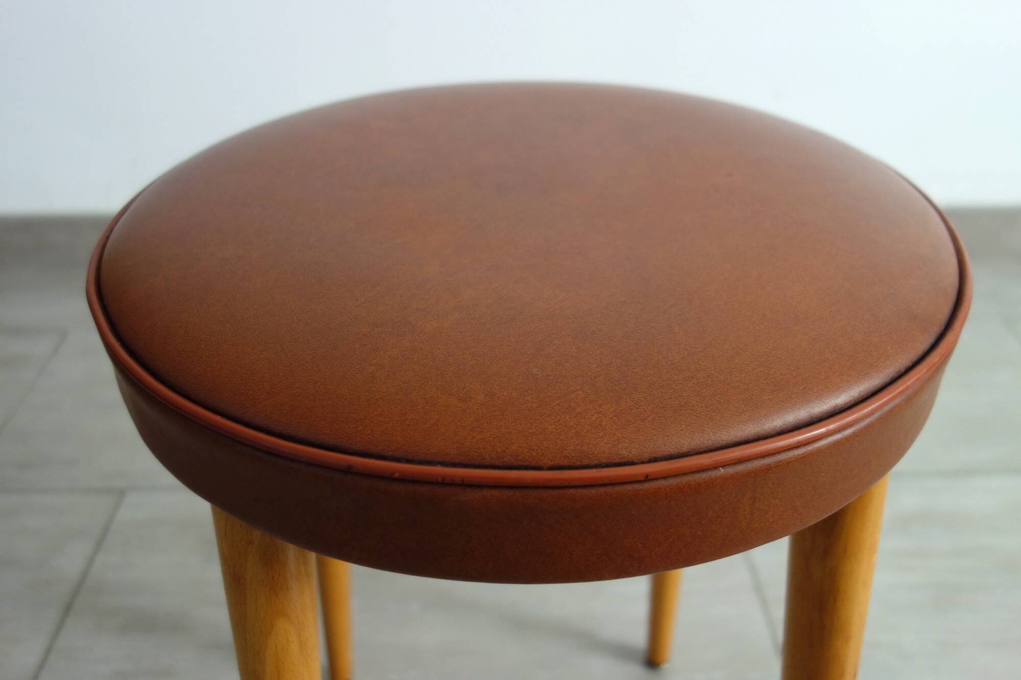 Baumann low stool from the 60s in brown leatherette