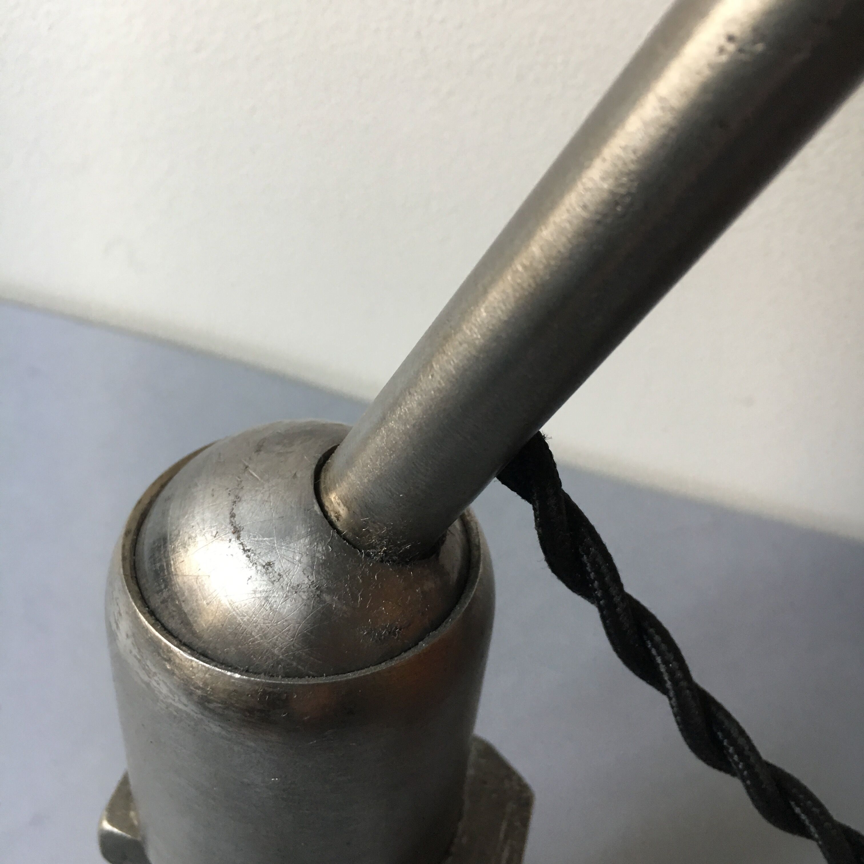 Old industrial lamp has vise 'mazda '.