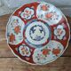 Antique Imari deep plate with red and blue floral decoration, 21.5cm.