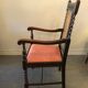 Fauteuil en bois sculpté et cannage