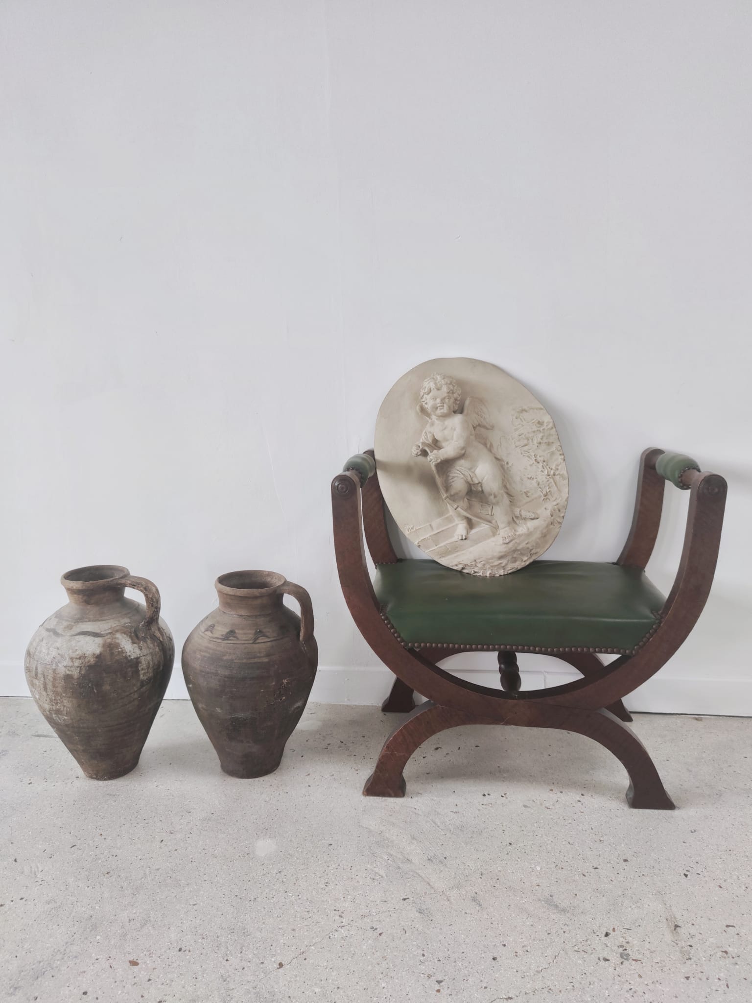 Green curule armchair