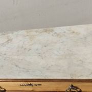 Old chest of drawers with white marble.