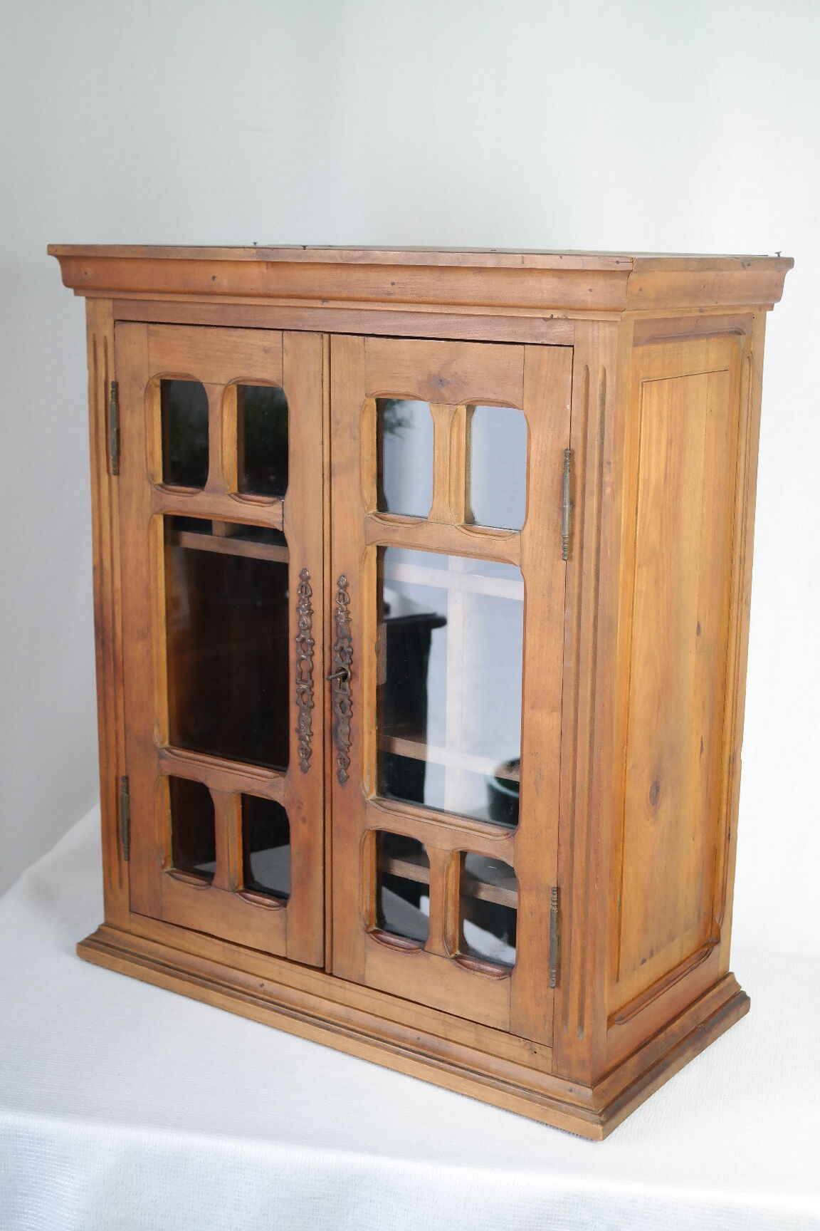 Antique walnut display cabinet from the 20th century.