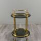 Rolling serving table in gold metal and smoked glass, 20th century