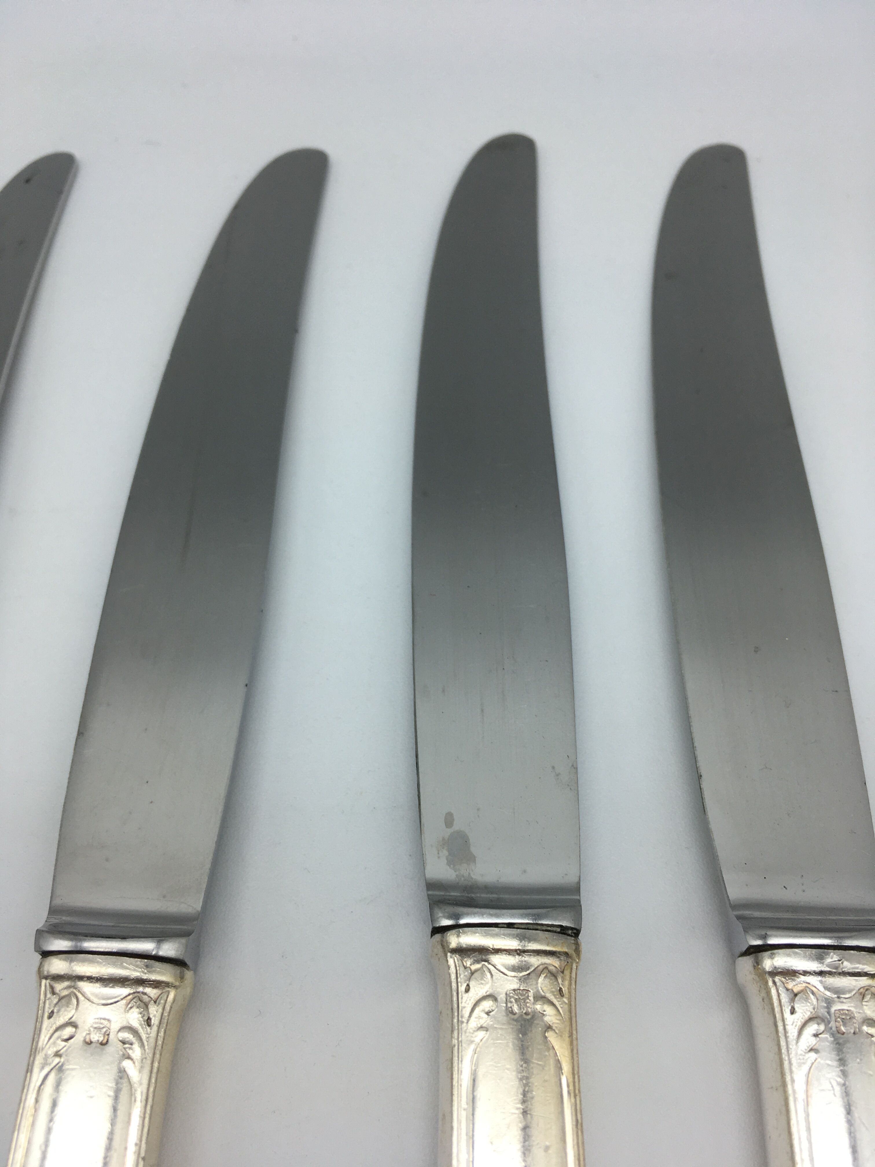 12 silver metal knives.