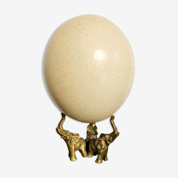 Ancient ostrich egg naturalized on bronze base representing 3 elephants