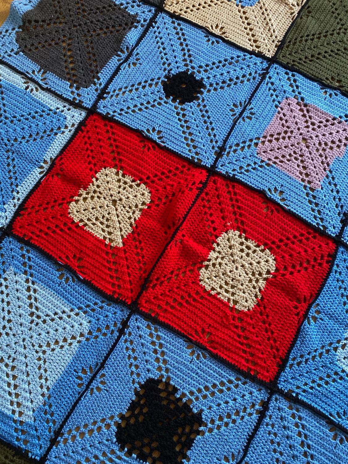 Hand-knitted patchwork blanket