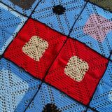 Hand-knitted patchwork blanket
