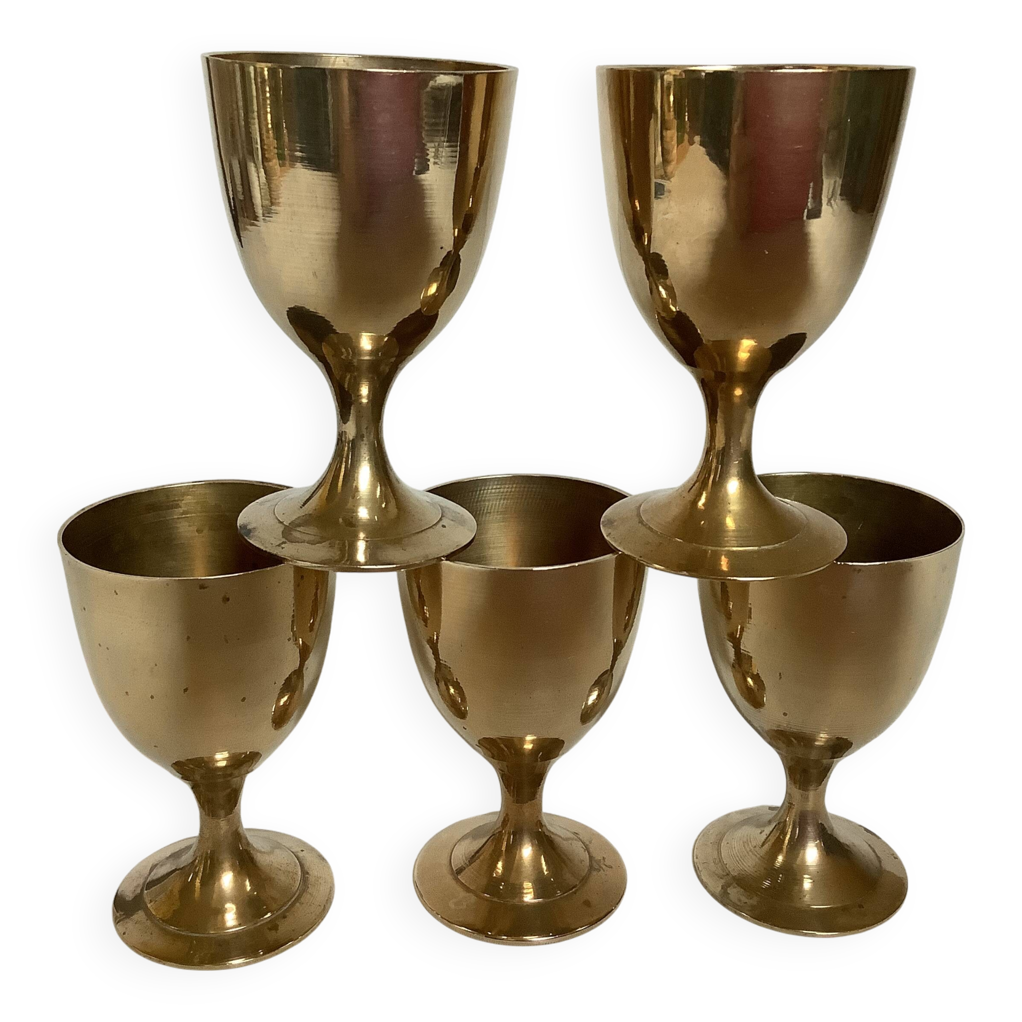 Five brass egg cups