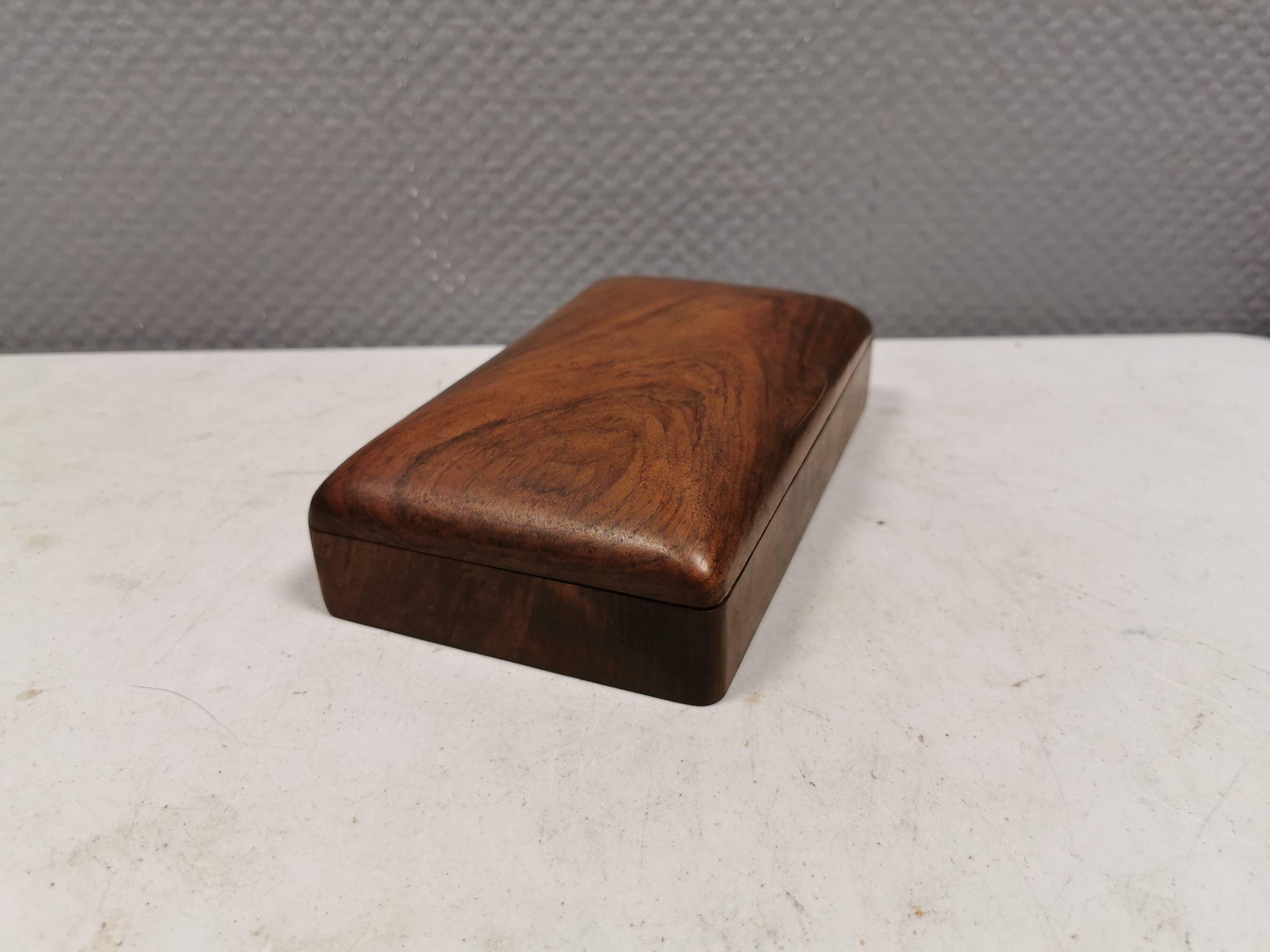 Wooden trinket box for storing jewellery, cigarettes or similar items.