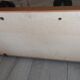1950s coat rack with mirror, metal hooks, and glass shelf.