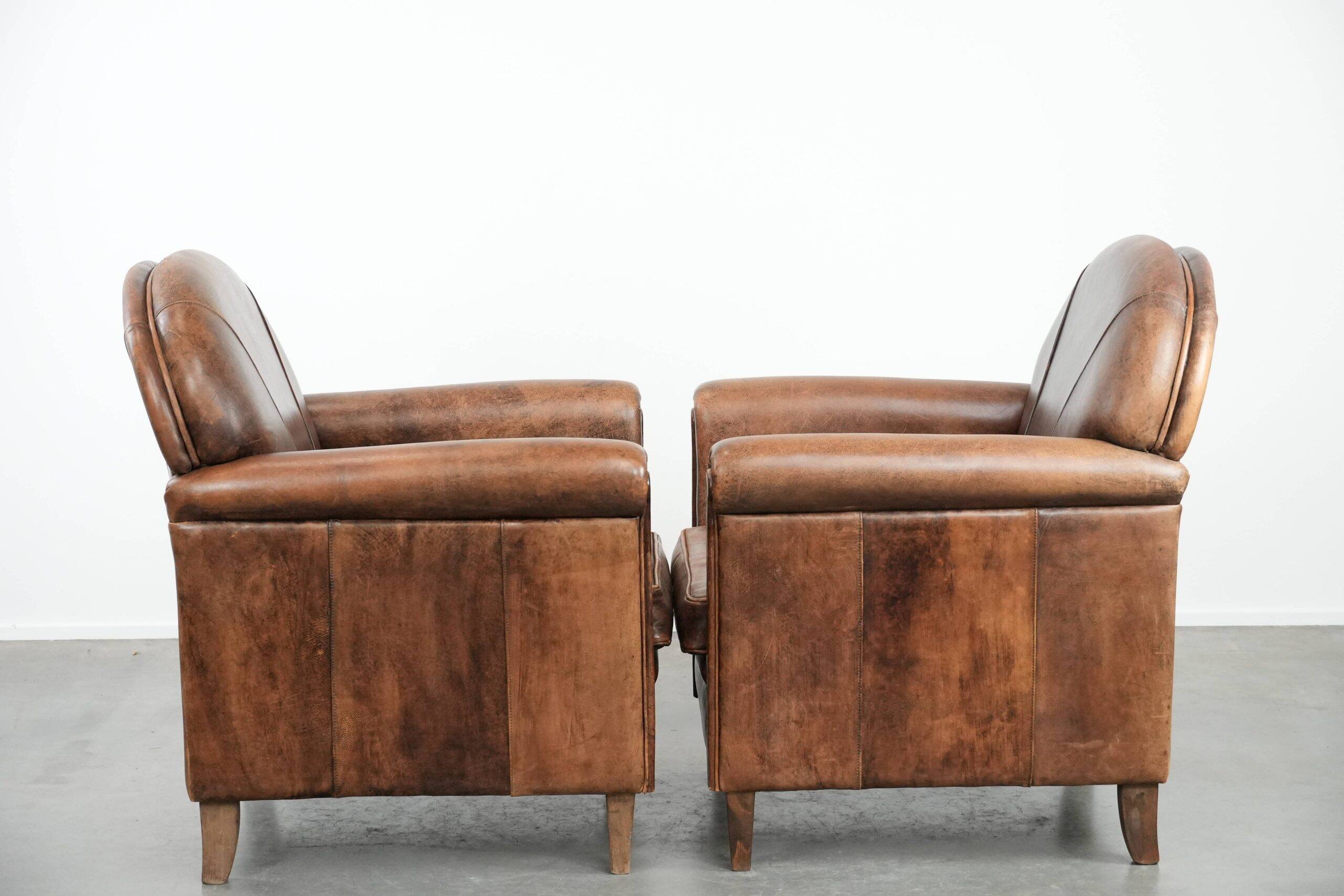 Set of 2 vintage sheepskin armchairs with a characterful appearance