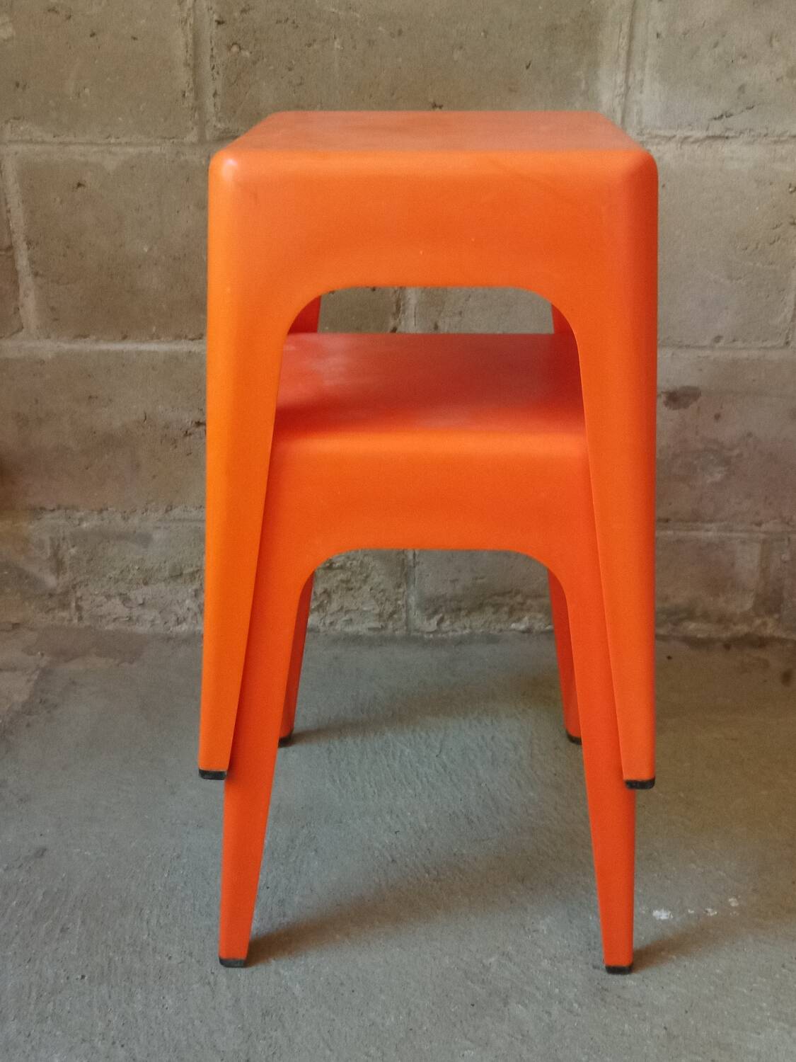 Pair of AMI stools in orange plastic