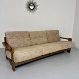 Old 3-seater sofa in solid wood, Maison Regain design, from the 70s.
