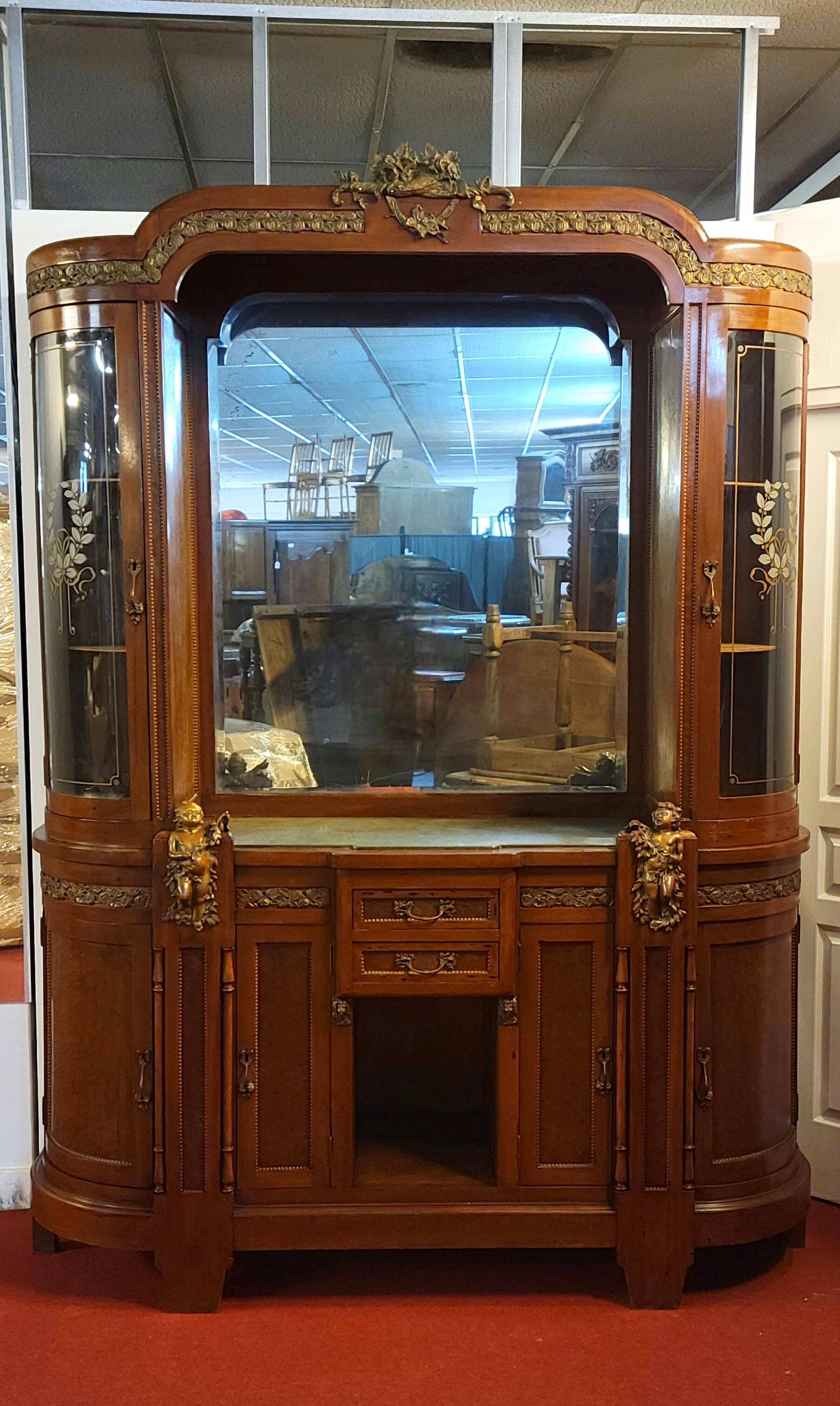 Empire style half-moon shaped mahogany bookcase with putti