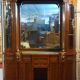 Empire style half-moon shaped mahogany bookcase with putti