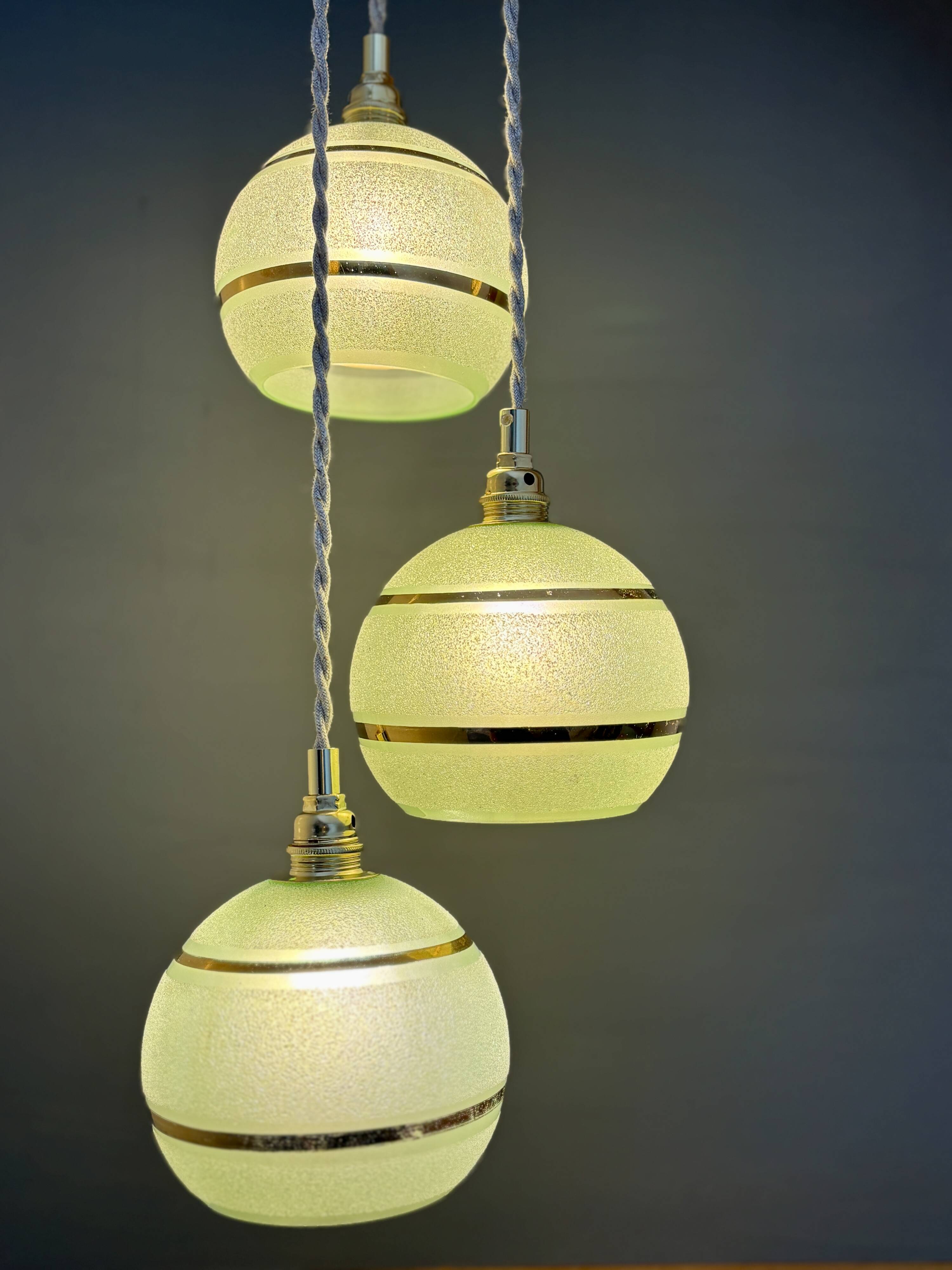 Suspension triple vintage glass globes in frosted green and gold.