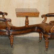 High Victorian leather tête-à-tête canapé with a walnut burr chessboard.