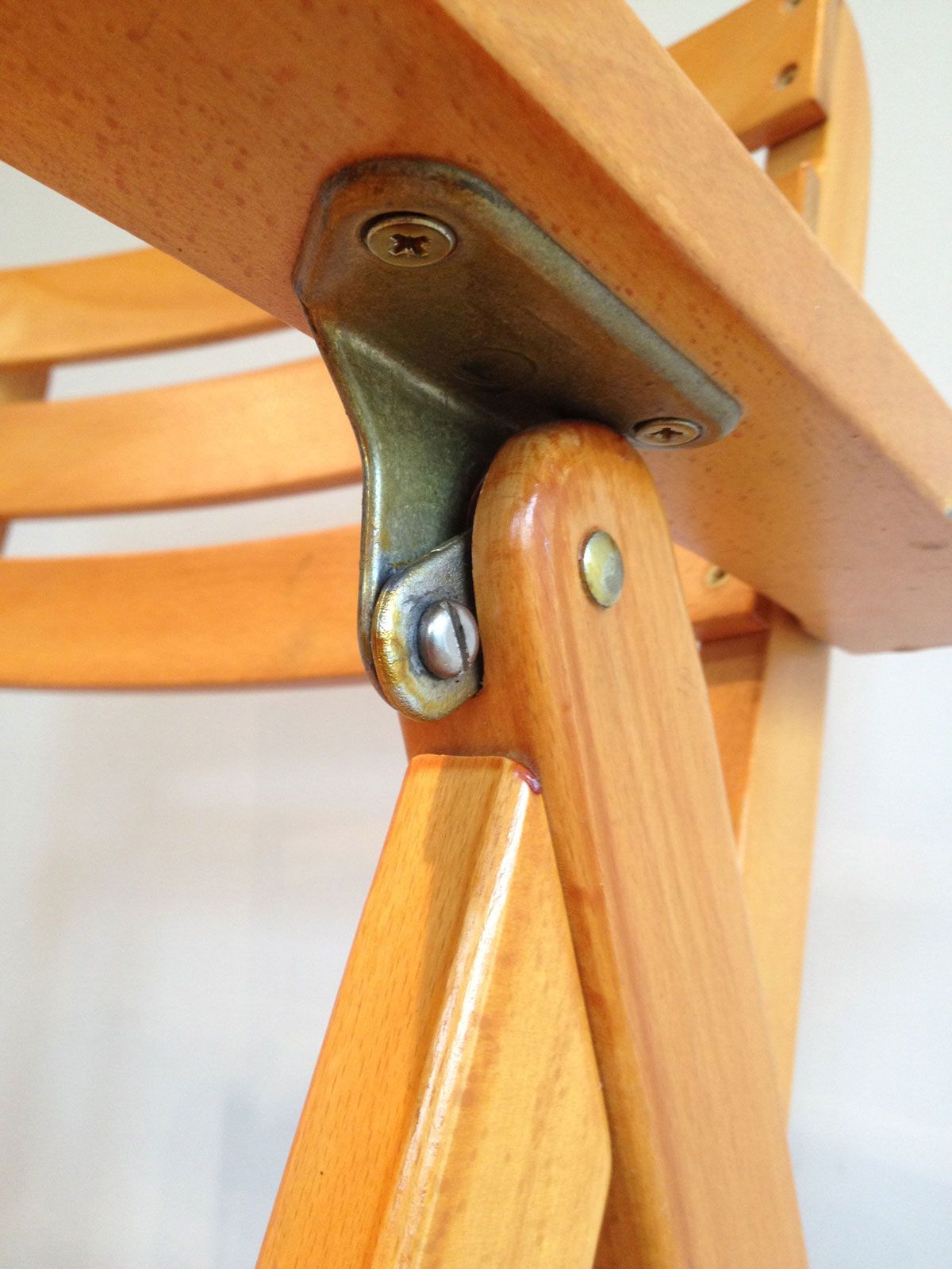 Pair of varnished wooden folding armchairs signed Clairitex.