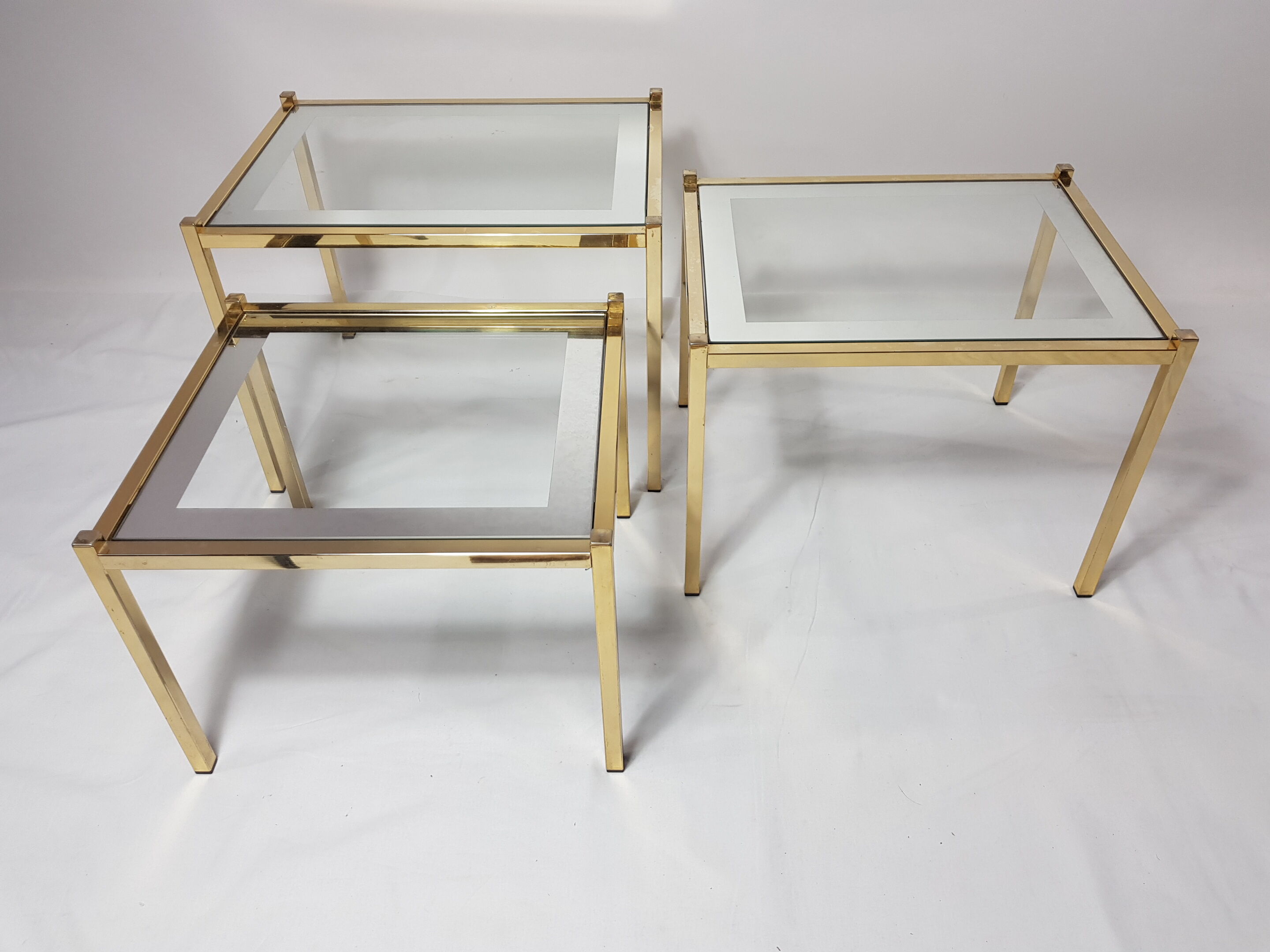 Three trundle tables gilded brass and silver 60s