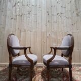 Pair of Louis XVI cabriolet armchairs with medallion backrest.