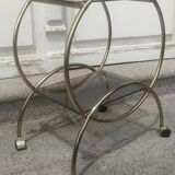 Service console with design / gilded metal wheels and smoked glass