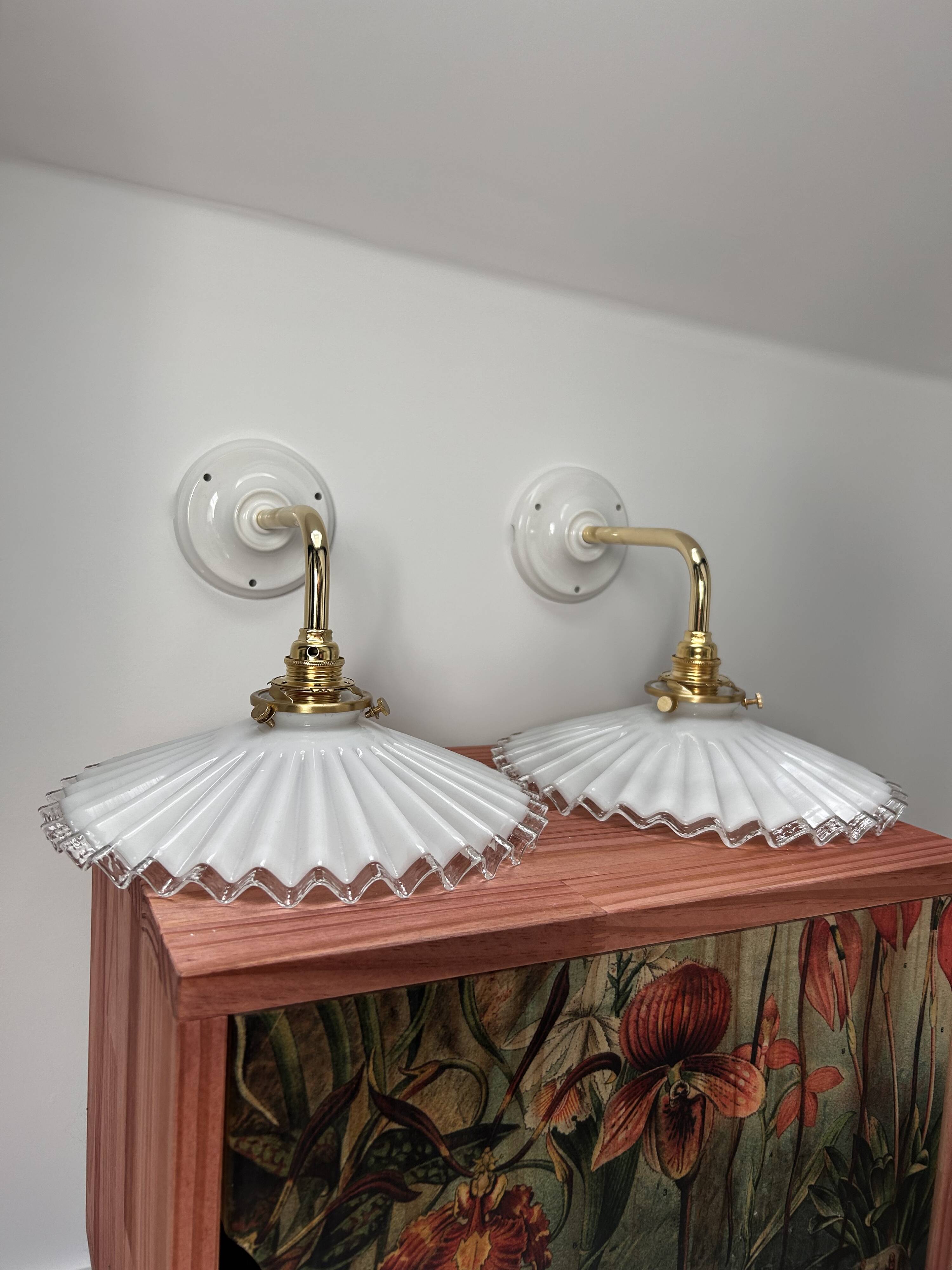 Two wall sconces in serrated white opaline