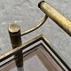 Mid Century Modern bar cart with 2 levels in brass and tinted glass.