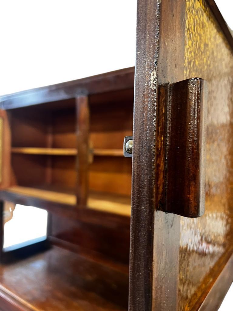 Vintage wooden display cabinet with yellow glass.
