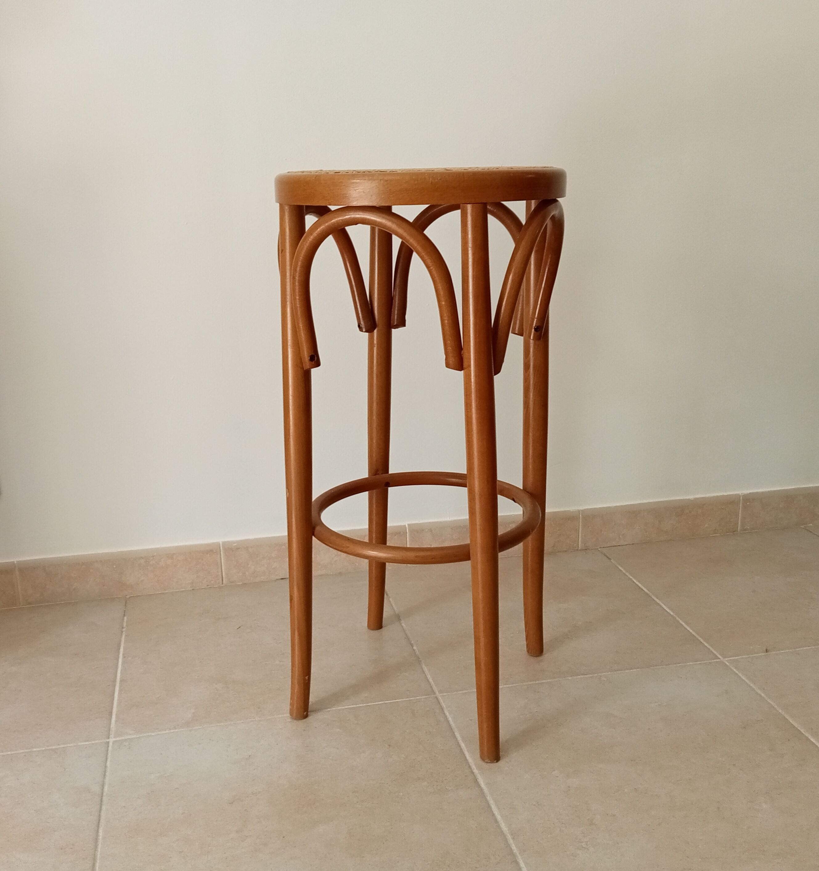 Vintage curved wooden high stool and tanned seat