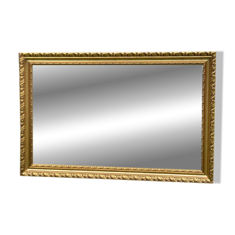 Large beveled mirror in wood and gilded stucco