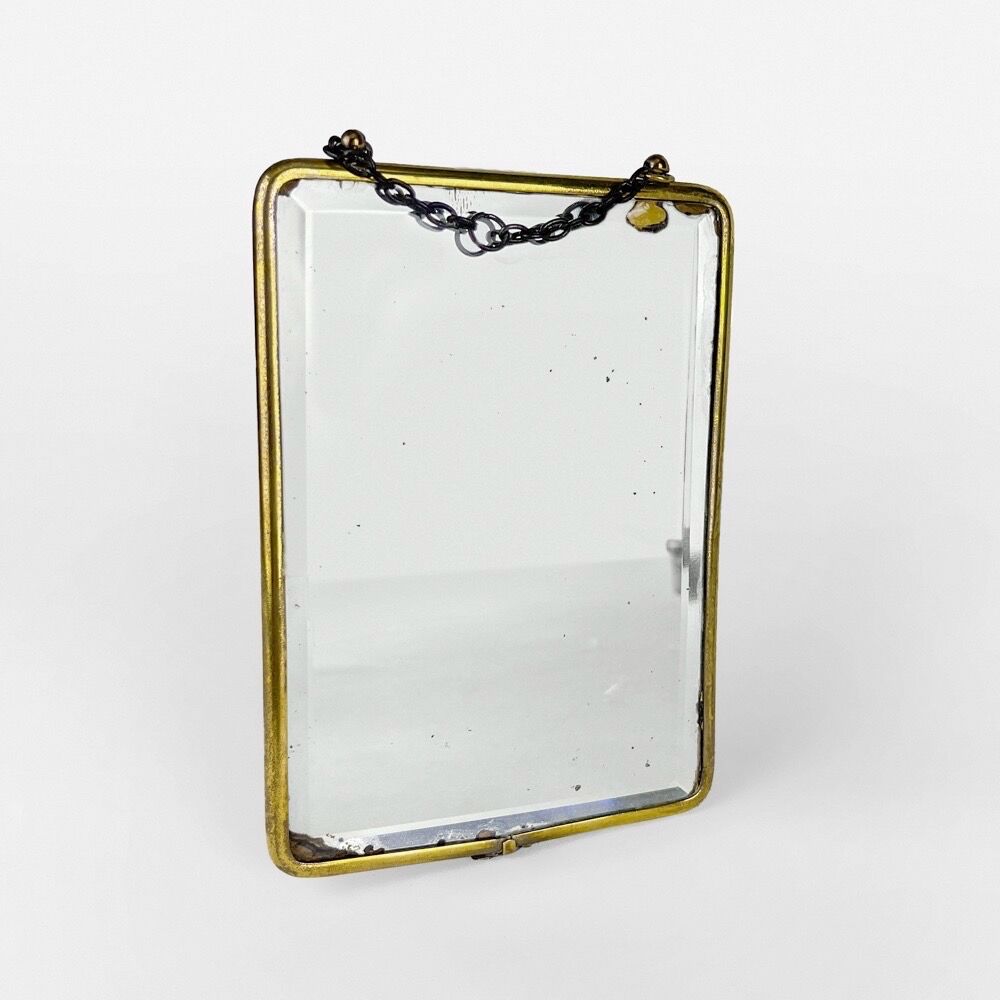 Old barber mirror in brass and beveled glass