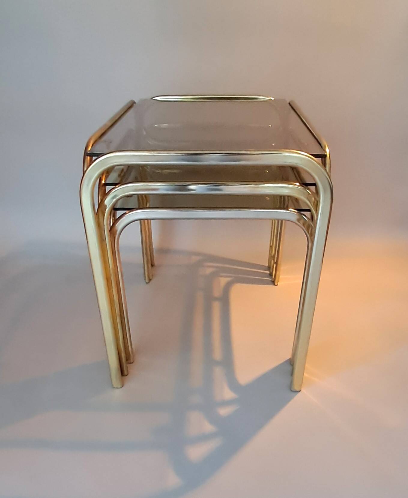 3 vintage golden nesting tables with smoked glass.
