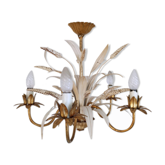 Vintage wrought iron chandelier decorated with golden and beige reeds