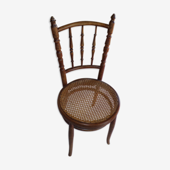 Curved wooden chair, turned and seated in cannage