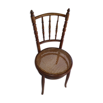 Curved wooden chair, turned and seated in cannage